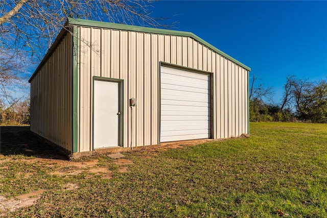 garage featuring a lawn