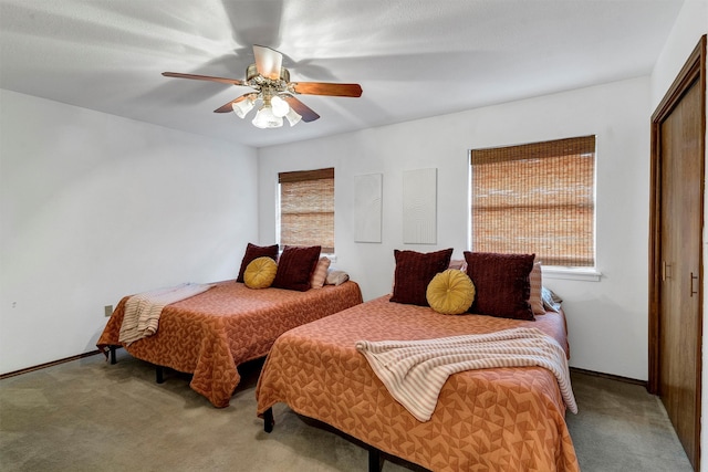 bedroom featuring carpet flooring, ceiling fan, and a closet