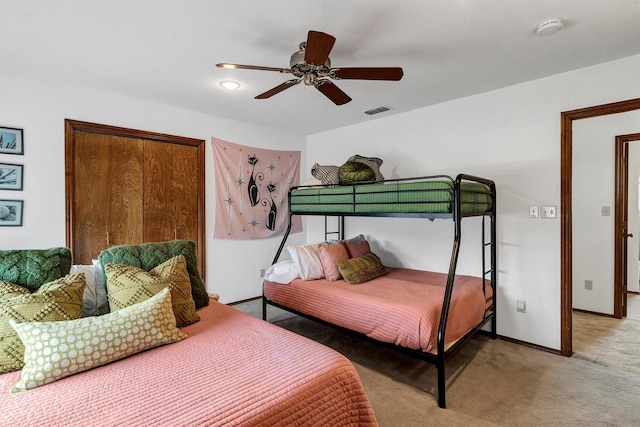 bedroom with ceiling fan, a closet, and carpet floors