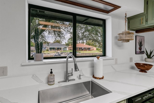 kitchen featuring green cabinets, dishwasher, and sink