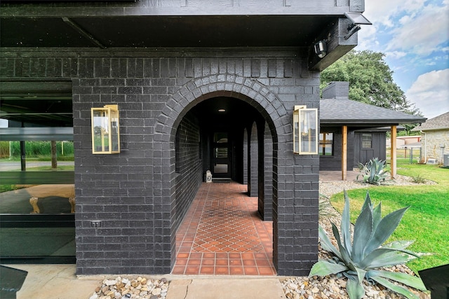 doorway to property with a lawn