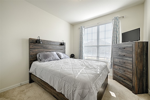 bedroom with light colored carpet and vaulted ceiling