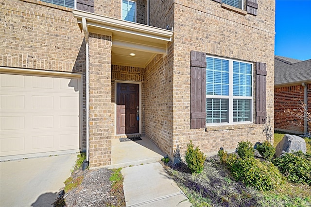 view of exterior entry with a garage