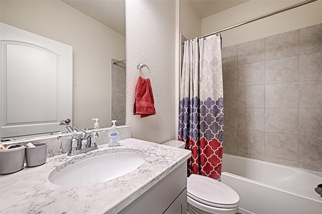 full bathroom with vanity, shower / tub combo, and toilet