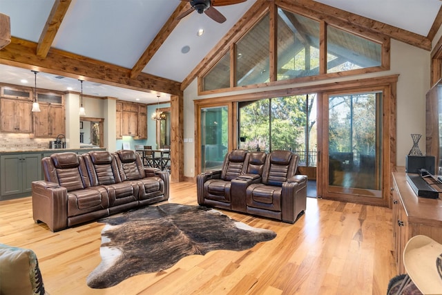 living room featuring high vaulted ceiling, beam ceiling, ceiling fan with notable chandelier, and light hardwood / wood-style floors