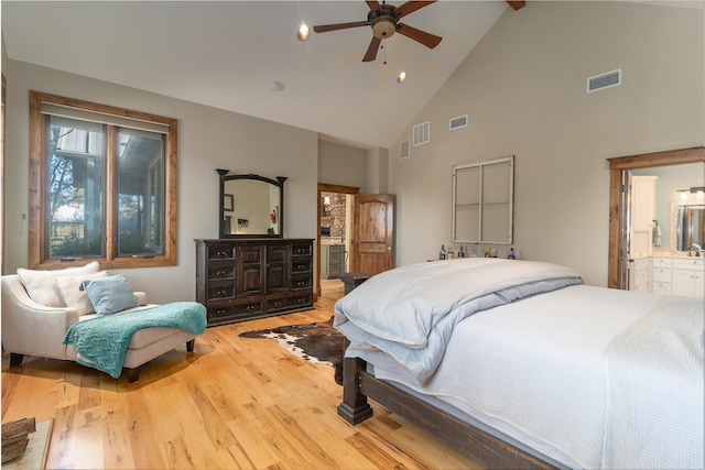 bedroom featuring connected bathroom, light hardwood / wood-style floors, high vaulted ceiling, and ceiling fan