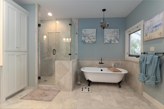 bathroom featuring tile walls, a notable chandelier, and plus walk in shower