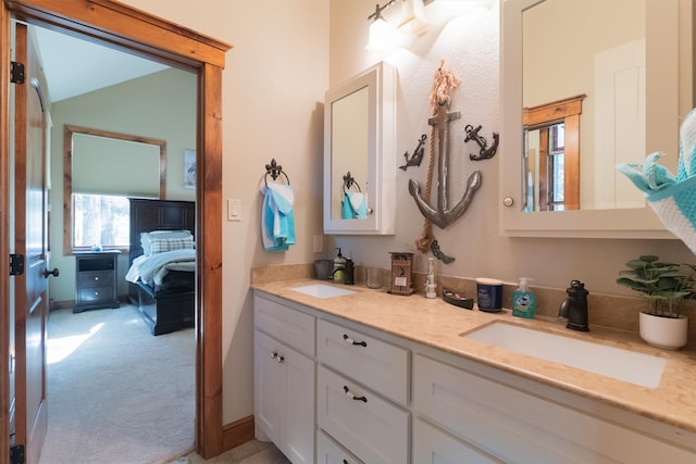 bathroom with vanity and lofted ceiling