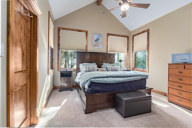 carpeted bedroom with multiple windows, beam ceiling, high vaulted ceiling, and ceiling fan