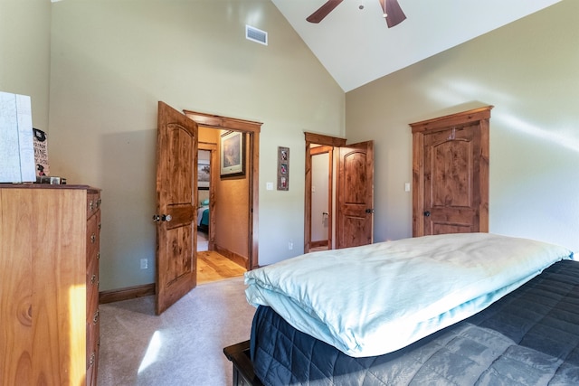 bedroom with ceiling fan and high vaulted ceiling