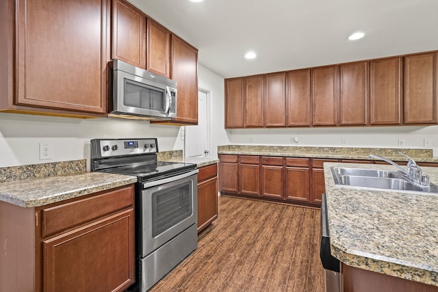 kitchen featuring sink, stainless steel appliances, and dark hardwood / wood-style floors