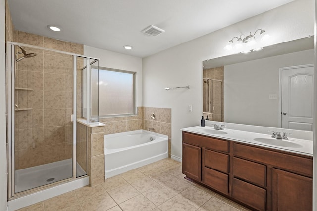 bathroom with independent shower and bath, vanity, and tile patterned floors