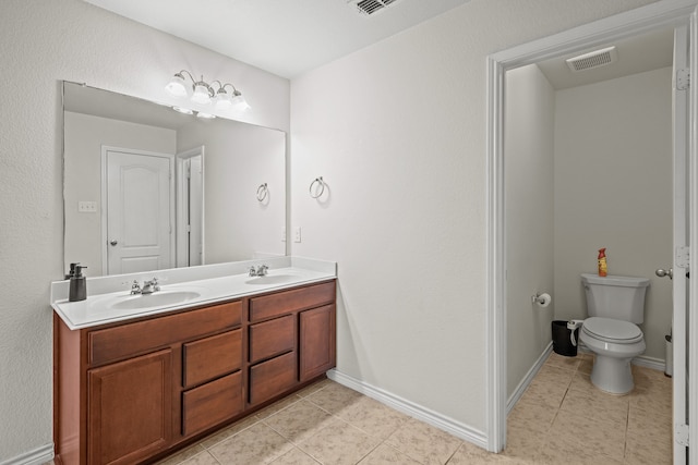 bathroom featuring tile patterned floors, vanity, and toilet