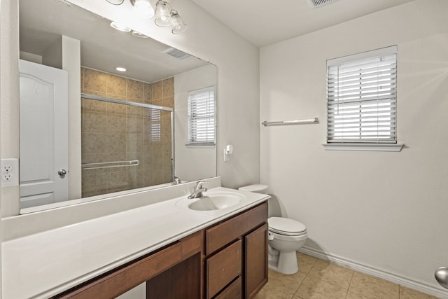 bathroom with tile patterned flooring, vanity, toilet, and walk in shower