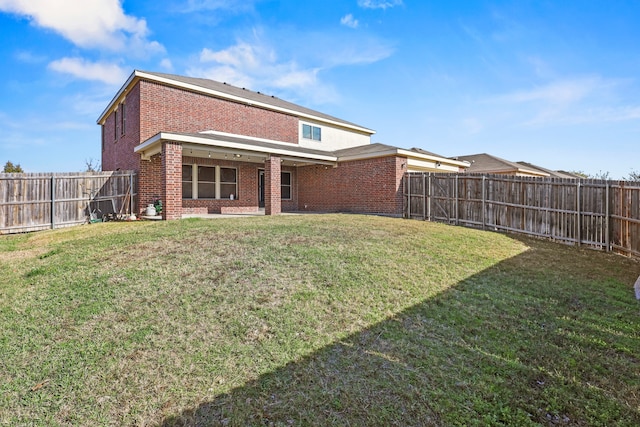 rear view of property featuring a yard