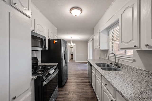 kitchen with sink, decorative light fixtures, dark hardwood / wood-style flooring, white cabinetry, and stainless steel appliances