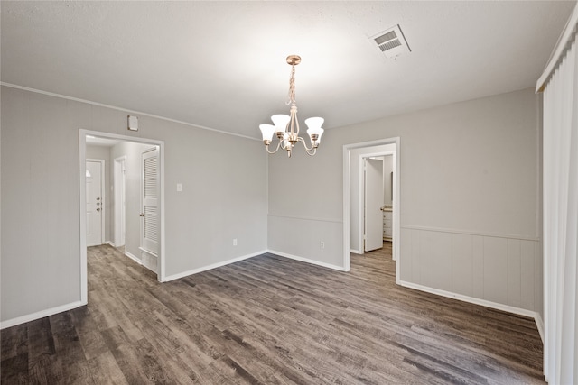 interior space featuring ornamental molding, dark wood-type flooring, and a notable chandelier