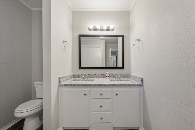 bathroom with vanity, toilet, and crown molding