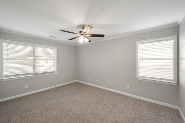 spare room featuring carpet, ceiling fan, and ornamental molding