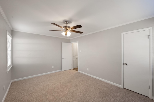 unfurnished room featuring light carpet, ceiling fan, and crown molding