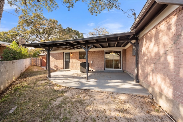 back of property with a patio area and central AC