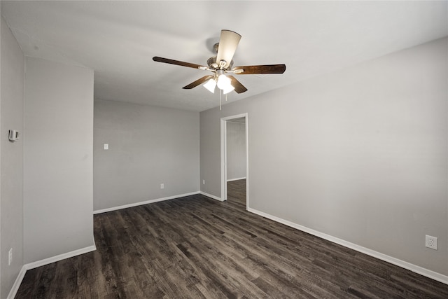 empty room featuring ceiling fan and dark hardwood / wood-style floors