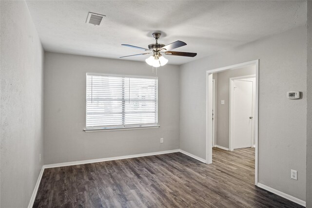 empty room featuring a textured ceiling, dark hardwood / wood-style flooring, and ceiling fan