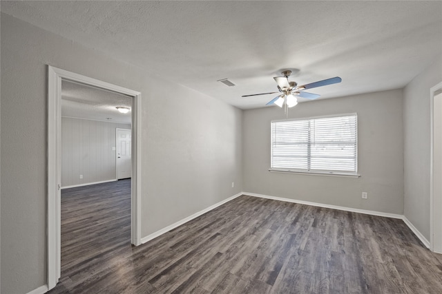 unfurnished room featuring ceiling fan, dark hardwood / wood-style flooring, and a textured ceiling