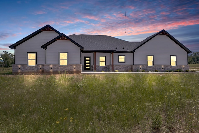 view of back house at dusk