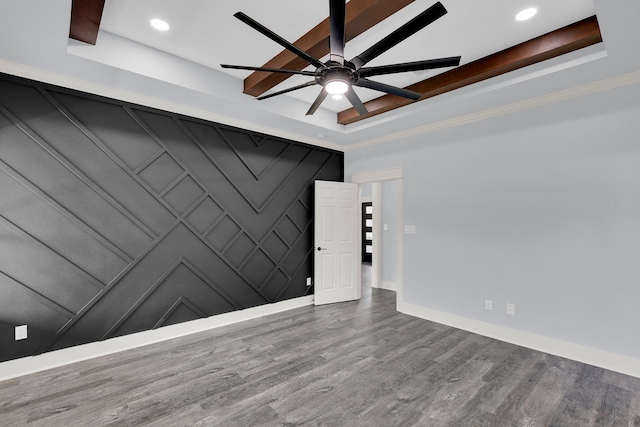 unfurnished room featuring hardwood / wood-style floors, a raised ceiling, and ceiling fan