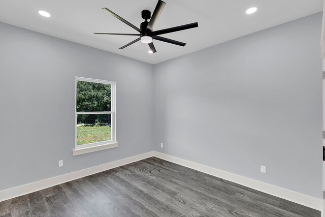 spare room with ceiling fan and dark wood-type flooring