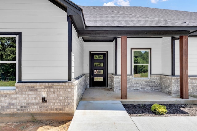 entrance to property featuring covered porch