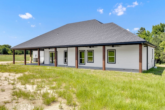 back of property with ceiling fan and a patio