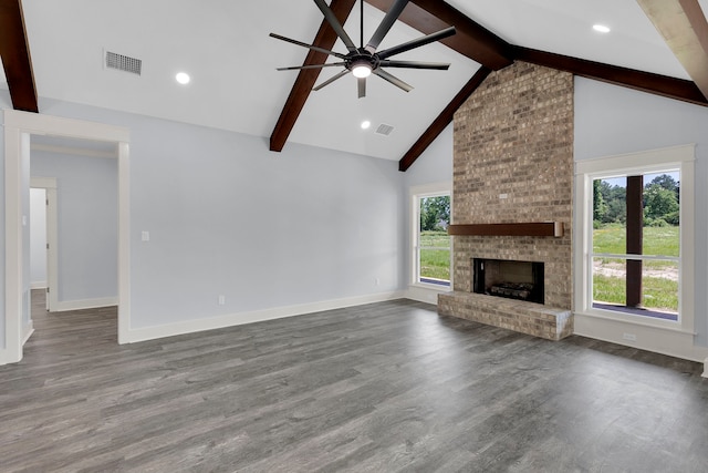 unfurnished living room with ceiling fan, beam ceiling, wood-type flooring, and a fireplace