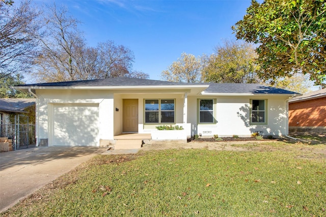 ranch-style house with covered porch, a garage, and a front yard