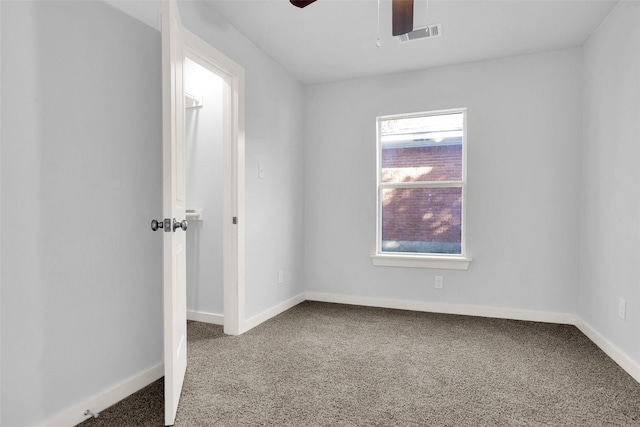 empty room with ceiling fan and carpet