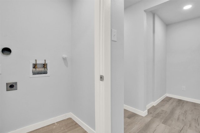 washroom featuring washer hookup, light wood-type flooring, and electric dryer hookup