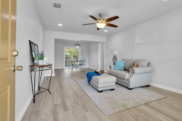 living room featuring light hardwood / wood-style flooring and ceiling fan