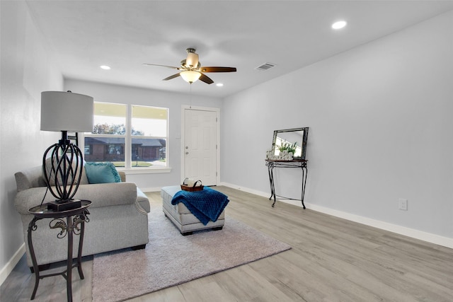 sitting room with light hardwood / wood-style floors and ceiling fan