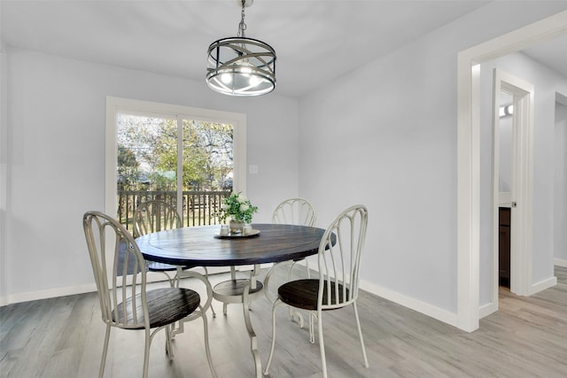 dining area featuring a chandelier and light hardwood / wood-style floors