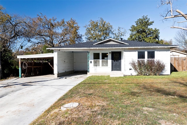 single story home featuring a front lawn and a carport