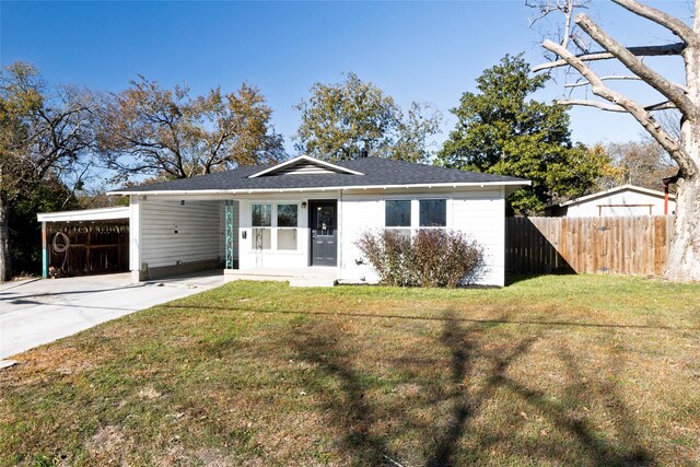 view of front facade with a front lawn and a carport