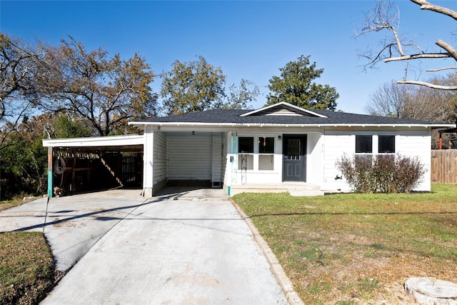 ranch-style house featuring a front yard and a carport