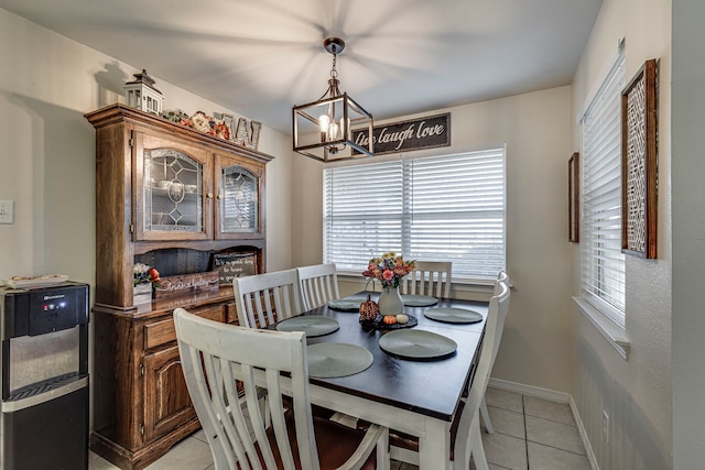 dining room featuring an inviting chandelier and light tile patterned floors