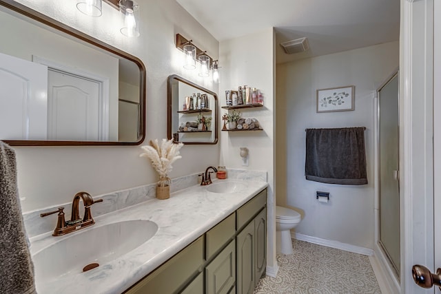 bathroom with toilet, a shower with shower door, tile patterned floors, and vanity