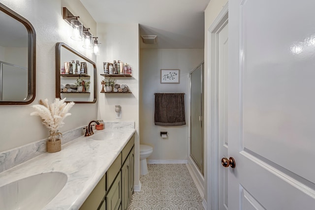 bathroom with vanity, toilet, walk in shower, and tile patterned flooring