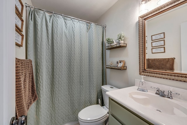 bathroom with vanity, toilet, and curtained shower