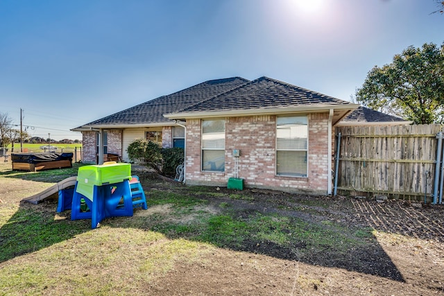 rear view of house featuring a lawn