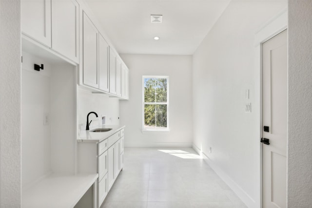 clothes washing area featuring sink