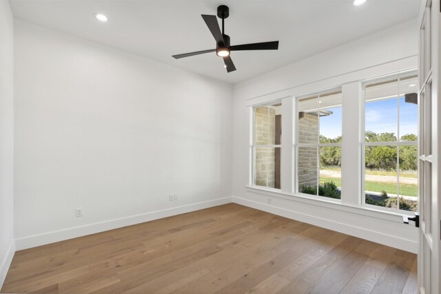 empty room featuring ceiling fan, light hardwood / wood-style flooring, and french doors